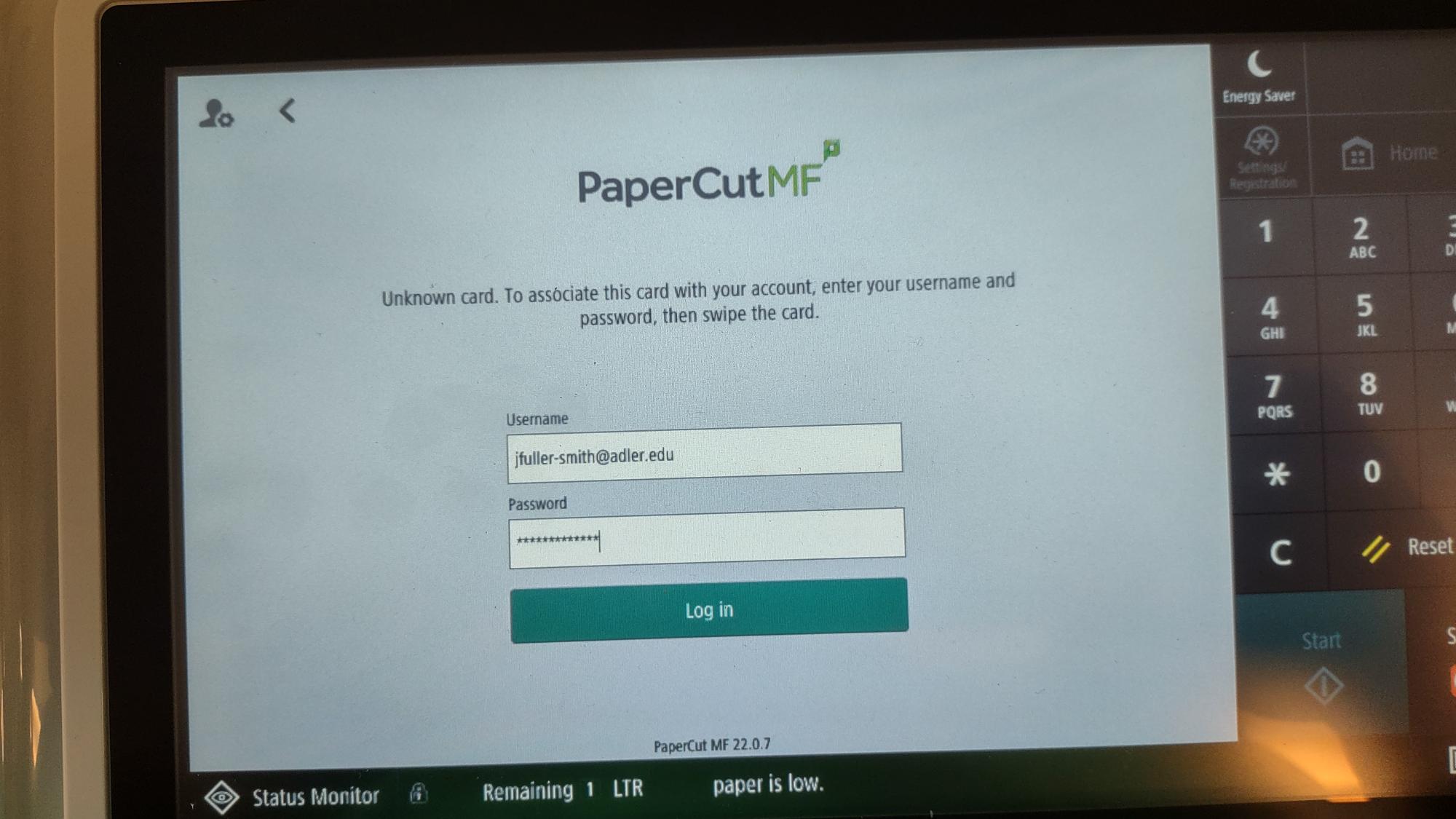 Printer login screen with a username and password entry field, followed by a green Log in button. Accompanying these fields is the message "Unknown card. To associate this card with your account, enter your username and password, then swipe the card."