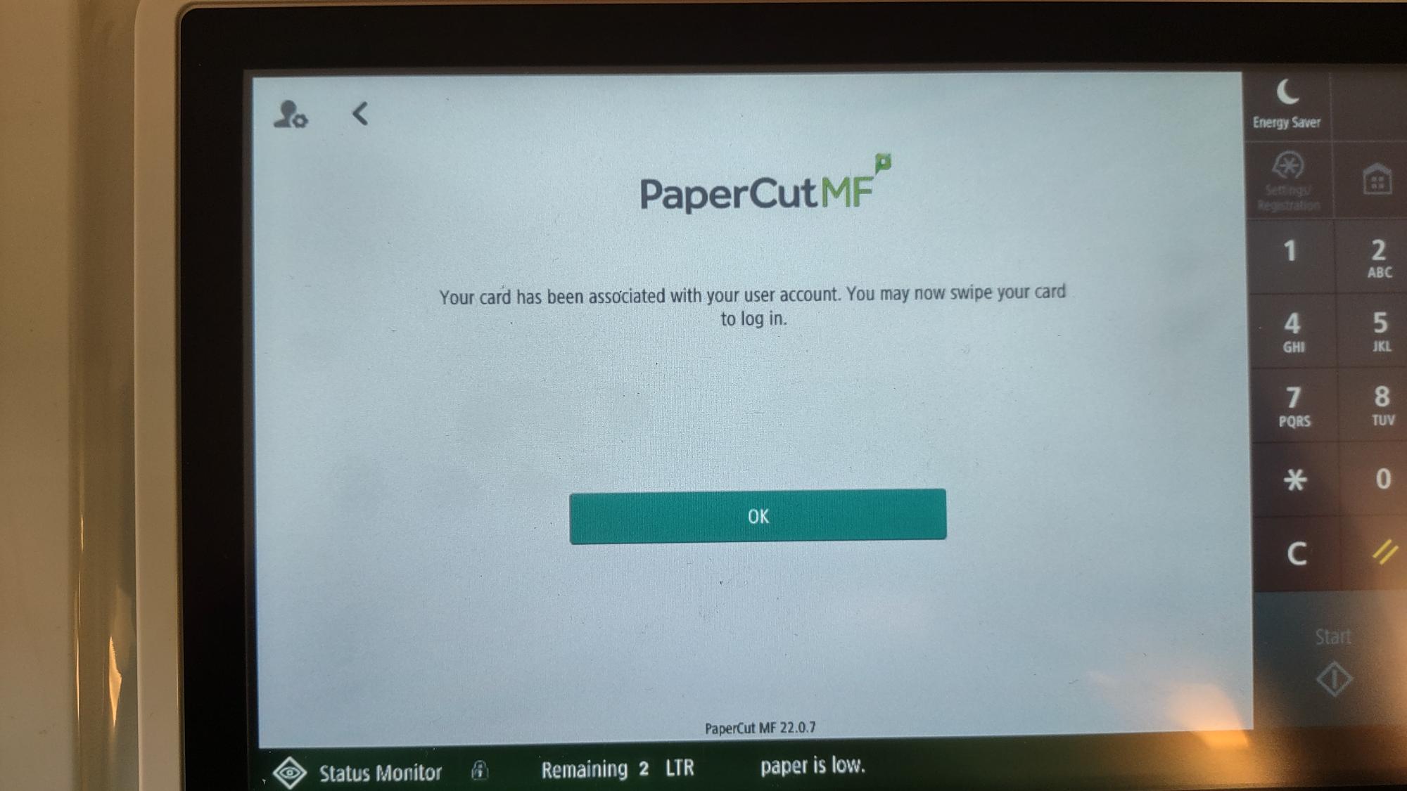 Printer display with the message "Your card has been associated with your user account. you may now swipe your card to log in."